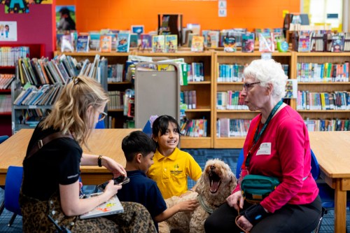 Yesli, center right, pets Sage, a therapy dog, at Valley View Elementary School on April 29, 2026, in Columbia Heights, Minn. (Ellen Schmidt/MinnPost via AP)