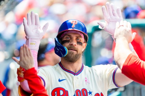 Philadelphia Phillies' Bryce Harper is congratulated in the dugout after he hit a solo home run in the first inning of a baseball game against the Colorado Rockies, Sunday, May 10, 2026, in Philadelphia. (AP Photo/Laurence Kesterson)