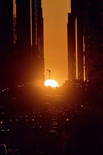The setting sun is framed between buildings during Manhattanhenge along 42nd Street, Thursday, May 28, 2026, in New York. (AP Photo/Andres Kudacki)