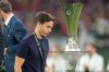 Rayo's head coach Inigo Perez passes the trophy of the Europa Conference League after the final soccer match between Crystal Palace and Rayo Vallecano in Leipzig, Germany, Wednesday, May 27, 2026. (AP Photo/Michael Probst)