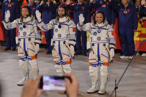 FILE - Chinese astronaut for the Shenzhou 21 mission, from left, Zhang Hongzhang, Wu Fei and Zhang Lu wave as they attend a see-off ceremony for their manned space mission at the Jiuquan Satellite Launch Center in northwestern China, Friday, Oct. 31, 2025. (AP Photo/Andy Wong, File)