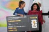 Mexican President Claudia Sheinbaum gives a copy of a symbolic ticket for the 2026 FIFA World Cup opening match to amateur soccer player Yolett Cervantes during her daily news conference at the National Palace in Mexico City, on Friday, May 29, 2026. (AP Photo/Fernando Llano)