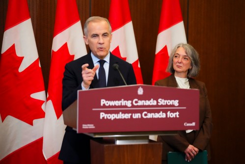 Prime Minister Mark Carney makes an announcement alongside Minister of Environment and Climate Change Julie Dabrusin, right, on Parliament Hill in Ottawa on Thursday, May 14, 2026. THE CANADIAN PRESS/Sean Kilpatrick