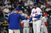 New York Mets pitcher David Peterson, right, hands the ball to New York Mets manager Carlos Mendoza as he leaves during the sixth inning of a baseball game against the Cincinnati Reds Tuesday, May 26, 2026, in New York. (AP Photo/Frank Franklin II)