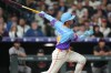 Colorado Rockies' Ezequiel Tovar follows the flight of his two-run home run off San Francisco Giants relief pitcher Caleb Kilian in the ninth inning of a baseball game Friday, May 29, 2026, in Denver. (AP Photo/David Zalubowski)