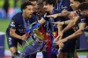 PSG players celebrate with a trophy after the Champions League final soccer match between Paris Saint-Germain and Arsenal in Budapest, Hungary, Saturday, May 30, 2026. AP Photo/Armin Durgut)
