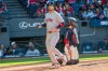 Boston Red Sox' Marcelo Mayer, left, scores on a double by Connor Wong as Cleveland Guardians' Austin Hedges looks away during the sixth inning of a baseball game, Saturday, May 30, 2026, in Cleveland. (AP Photo/Phil Long)