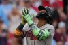 Atlanta Braves right fielder Ronald Acuña Jr. reacts as he crosses home plate after hitting a solo home run during the third inning of a baseball game against the Cincinnati Reds in Cincinnati, Saturday, May 30, 2026. (AP Photo/Carolyn Kaster)