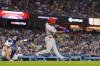 Philadelphia Phillies' Edmundo Sosa, right, hits a two-run home run as Los Angeles Dodgers catcher Will Smith watches during the eighth inning of a baseball game Saturday, May 30, 2026, in Los Angeles. (AP Photo/Mark J. Terrill)