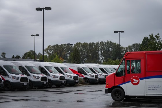 Vehicles at a Canada Post delivery depot in Burnaby, B.C., in 2025. (Darryl Dyck / The Canadian Press files)