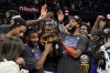 The New York Knicks hold the Eastern Conference Championship trophy after Game 4 in the Eastern Conference finals NBA basketball playoffs series against the Cleveland Cavaliers in Cleveland, Monday, May 25, 2026. (AP Photo/Sue Ogrocki)