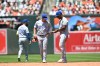 Toronto Blue Jays right fielder Jesús Sánchez, right, looks at his hand after something was thrown from the stands during a baseball game against the Baltimore Orioles, Sunday, May 31, 2026, in Baltimore. (AP Photo/Gail Burton)