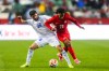 Canada's Jayden Nelson (29) battles against Uzbekistan's Aziz Amonov (28) during second half World Cup Friendly soccer action in Edmonton on Monday, June 1, 2026. THE CANADIAN PRESS/Codie McLachlan