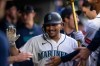 Seattle Mariners' Josh Naylor celebrates in the dugout after hitting a solo home run during the seventh inning of a baseball game against the New York Mets, Monday, June 1, 2026, in Seattle. (AP Photo/Stephen Brashear)