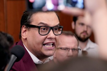 FILE - Rep. George Santos, R-N.Y., talks to reporters as House Republicans hold a caucus meeting at the Capitol in Washington, Oct. 13, 2023. (AP Photo/Mariam Zuhaib, File)