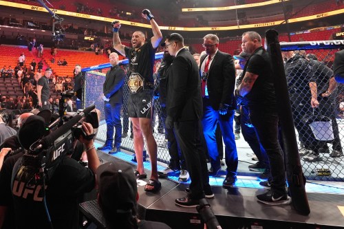 Carlos Ulberg, centre left, of New Zealand, celebrates after defeating Jiri Prochazka of Czechia by TKO to win their light heavyweight title bout at a UFC 327 mixed martial arts event on April 11, 2026, in Miami. (AP Photo/Rebecca Blackwell)