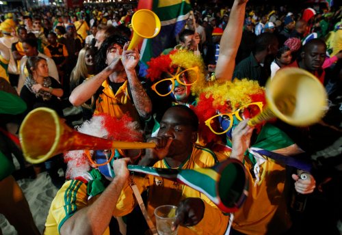 FILE - In this Wednesday, June 16, 2010 file photo, South African fans, blow their vuvuzelas as they cheer at a beach in Durban, South Africa. (AP Photo/Hussein Malla, File)
