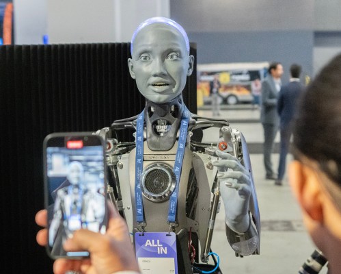 People take photos of an AI robot at the All In artificial intelligence conference Wednesday, September 27, 2023 in Montreal. THE CANADIAN PRESS/Ryan Remiorz