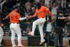 Houston Astros' Christian Walker (8) and Isaac Paredes (15) celebrate their runs scored on Cam Smith's RBI triple for the go-ahead runs against the Pittsburgh Pirates during the eighth inning of a baseball game, Wednesday, June 3, 2026, in Houston. (AP Photo/Karen Warren)
