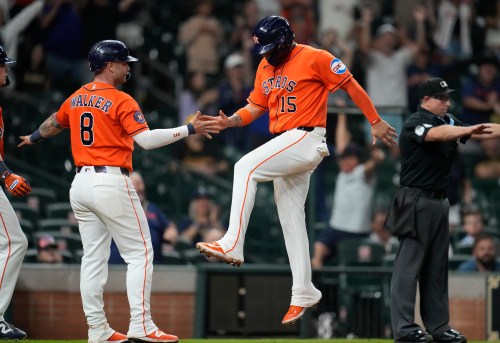Houston Astros' Christian Walker (8) and Isaac Paredes (15) celebrate their runs scored on Cam Smith's RBI triple for the go-ahead runs against the Pittsburgh Pirates during the eighth inning of a baseball game, Wednesday, June 3, 2026, in Houston. (AP Photo/Karen Warren)