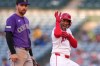 Los Angeles Angels' Jose Siri, right, gestures toward his dugout after hitting an RBI double as Colorado Rockies second baseman Edouard Julien looks on during the second inning of a baseball game Wednesday, June 3, 2026, in Anaheim, Calif. (AP Photo/Mark J. Terrill)