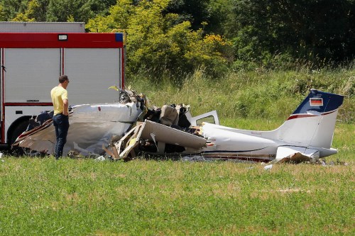 A person inspects a small plane which crashed near Medulin, Croatia, Thursday, June 4, 2026. (AP Photo/Goran Sebelic)