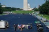 Interior Secretary Doug Burgum, center, poses for a photo with workers while touring the Lincoln Memorial Reflecting Pool after it was coated in a blue swimming pool surface ahead of the United States' 250th anniversary, Wednesday, June 3, 2026, in Washington. (AP Photo/Julia Demaree Nikhinson)