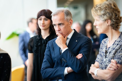Prime Minister Mark Carney, centre, and his wife Diana Fox Carney, right, visit technology startups at the Vector Institute, in Toronto on Thursday, June 4, 2026. THE CANADIAN PRESS/Arlyn McAdorey