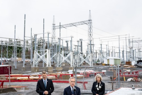 Prime Minister Mark Carney speaks as Minister of Housing and Infrastructure Gregor Robertson, left, and CEO of the Major Projects Office Dawn Farrell, right, listen during an announcement at Skeena Substation in Terrace, B.C., on Thursday, Nov. 13, 2025. THE CANADIAN PRESS/Ethan Cairns