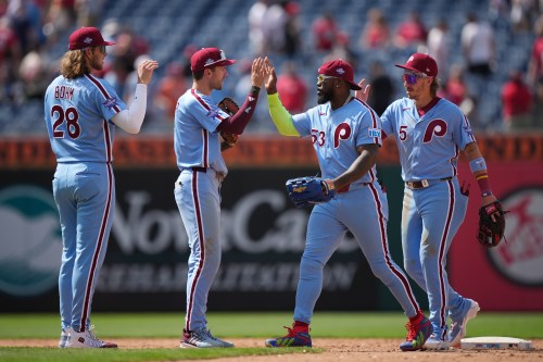 Philadelphia Phillies' players, from left, Alec Bohm, Trea Turner, Adolis García, and Bryson Stott celebrate after winning a baseball game against the San Diego Padres, Thursday, June 4, 2026, in Philadelphia. (AP Photo/Matt Rourke)