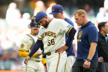 Milwaukee Brewers pitcher Grant Anderson (56) walks off the field with a team trainer after getting hit by a batted ball during the seventh inning of a baseball game against the San Francisco Giants, Thursday, June 4, 2026, in Milwaukee. (AP Photo/Kayla Wolf)
