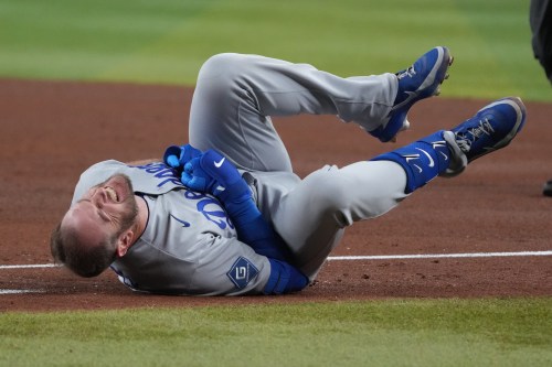 Los Angeles Dodgers' Max Muncy reacts after colliding with Arizona Diamondbacks first baseman Ildemaro Vargas in the fifth inning of a baseball game, Thursday, June 4, 2026, in Phoenix. (AP Photo/Rick Scuteri)