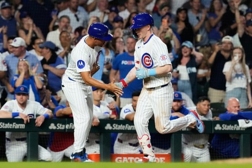 Chicago Cubs' Pete Crow-Armstrong, right, celebrates with third base coach Quintin Berry after hitting a solo home run during the sixth inning of a baseball game against the Athletics in Chicago, Thursday, June 4, 2026. (AP Photo/Nam Y. Huh)