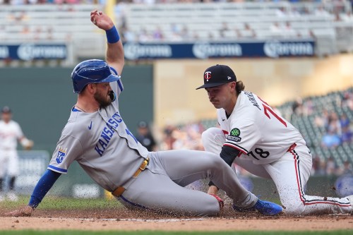 Kansas City Royals' Nick Loftin, left, beats a tag by Minnesota Twins starting pitcher Andrew Morris (78) to score during the second inning of a baseball game Thursday, June 4, 2026, in Minneapolis. (AP Photo/Abbie Parr)