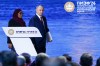 In this photo released by the Roscongress Foundation, Russian President Vladimir Putin, center, and Tanzanian President Samia Suluhu Hassan arrive to attend a plenary session at the St. Petersburg International Economic Forum in St. Petersburg, Russia, on Friday, June 5, 2026. (Vyacheslav Viktorov/Roscongress Foundation via AP)