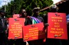 Activists hold placards during a protest against Uganda's anti-homosexuality bill at the Ugandan High Commission in Pretoria, South Africa, on Tuesday, April 4, 2023. (AP Photo/Themba Hadebe)