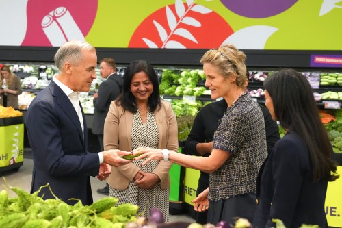 Prime Minister Mark Carney shows his wife Diana Fox Carney an Indian bitter melon at a FreshCo grocery store in Brampton, Ont., Friday, June 5, 2026. THE CANADIAN PRESS/Chris Young