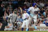 Chicago Cubs' Ian Happ, right, runs after hitting a one-run double during the ninth inning of a baseball game against the Athletics in Chicago, Thursday, June 4, 2026. (AP Photo/Nam Y. Huh)
