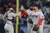Boston Red Sox first baseman Willson Contreras, front right, high-fives catcher Connor Wong, left, in front of pitcher Aroldis Chapman, back right, after defeating the New York Yankees in a baseball game Friday, June 5, 2026, in New York. (AP Photo/Adam Hunger)