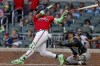 Atlanta Braves' Ronald Acuna Jr., left, hits an RBI single as Pittsburgh Pirates catcher Henry Davis, right looks on during the second inning of a baseball game, Friday, June 5, 2026, in Atlanta. (AP Photo/Erik S. Lesser)