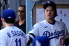 Los Angeles Dodgers starting pitcher Roki Sasaki, left, greets Shohei Ohtani I. The dugout prior to a baseball game against the Los Angeles Angels, Friday, June 5, 2026, in Los Angeles. (AP Photo/Mark J. Terrill)
