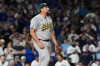 Athletics relief pitcher Joel Kuhnel looks at the scoreboard after Chicago Cubs' Seiya Suzuki, of Japan, hit a single during the ninth inning of a baseball game in Chicago, Thursday, June 4, 2026. (AP Photo/Nam Y. Huh)