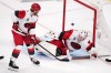 Carolina Hurricanes goaltender Brandon Bussi, right, is scored on by Carolina Hurricanes left wing Nikolaj Ehlers as defenseman Alexander Nikishin watches during the second overtime in Game 3 of the NHL hockey Stanley Cup Final series Saturday, June 6, 2026, in Las Vegas. (AP Photo/Candice Ward)