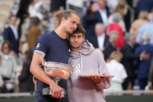Winner Alexander Zverev of Germany, left, and second placed Flavio Cobolli of Italy hug with their trophies after the men's final match at the French Open tennis tournament in Paris, Sunday, June 7, 2026. (AP Photo/Christophe Ena)