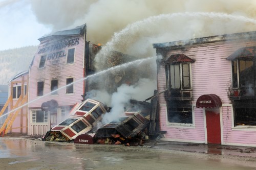 Firefighters work to extinguish a structure fire at the Westminster Hotel, a historic building from the gold-rush era, in Dawson City, Yukon, in a Sunday, May 17, 2026, handout photo. THE CANADIAN PRESS/Handout — Manu Keggenhoff (Mandatory Credit)