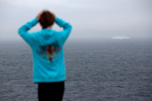 An iceberg is visible from a walking trail in Flatrock, N.L., a small community on the outskirts of St. John's, on Thursday, May 7, 2026. THE CANADIAN PRESS/Paul Daly