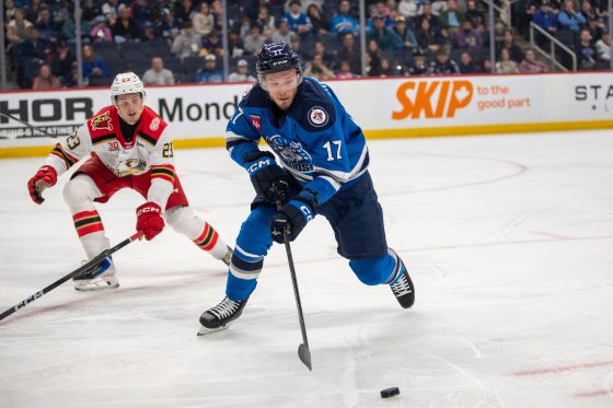 Manitoba Moose centre Danny Zhilkin (No. 17) controls the puck while Grand Rapids Griffins defenceman Anton Johansson (No. 17) covers him during Saturday's game. (Brook Jones / Free Press)