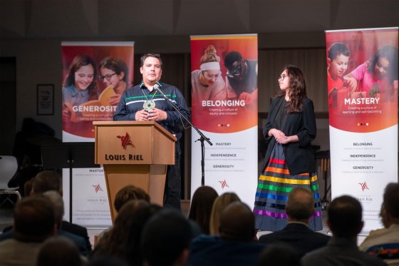 Niigaan Sinclair (left), with his daughter, Sarah Fontaine-Sinclair, at the renaming ceremony of École Sage Creek Bonavista to École Mazina-Giizhik in honour of his father, the late justice Murray Sinclair. (Brook Jones / Free Press)