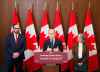 Prime Minister Mark Carney makes an announcement alongside Russ Shewchuk International Vice -President for International Brotherhood of Electrical Workers (IBEW) First District, left, and  Minister of Environment and Climate Change Julie Dabrusin, right, on Parliament Hill in Ottawa on Thursday, May 14, 2026. THE CANADIAN PRESS/Sean Kilpatrick