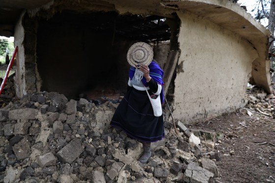 A Misak Indigenous woman stands amid the ruins of a house torn down during clashes with the Nasa community over a land dispute in Silvia, Colombia, Friday, May 22. (Santiago Saldarriaga / The Associated Press)